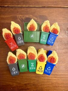 Toy dumpsters with handknit flames